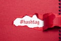 The word hashtag appearing behind torn paper