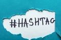 Word HASHTAG under torn color paper