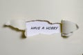 The word have a hobby appearing behind torn paper Royalty Free Stock Photo