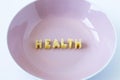 The word `health` made with pasta letters