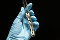 The word `health` in a glass test tube in the hands of a doctor in medical gloves on a black background, concept Royalty Free Stock Photo