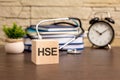 the word Health and Safety Executive is written on wooden cubes near a stethoscope on a wooden background. medical