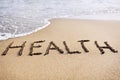 Word health written in the beach sand Royalty Free Stock Photo