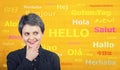 Word hello with different translations on the yellow wall. Multilingual woman learning and speaking many languages. International