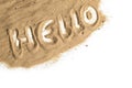 Word Hello written in sand on a white background, welcome concept for tourism and vacations on beach and sea, copy space, view Royalty Free Stock Photo