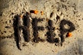 The word `help` written on the sand. Panic, epidemic concept. Abstract danger background. Royalty Free Stock Photo