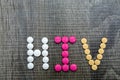 The word HIV(Human Immunodeficiency Virus) written whith pills o