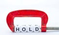 The word hold in a red clamp Royalty Free Stock Photo