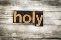 Holy Letterpress Word on Wooden Background
