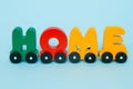 Word Home made of letters train cars alphabet. Bright colors of red yellow green and blue on a white background. Early childhood e Royalty Free Stock Photo