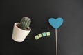 The word Home in Wooden Letter Blocks, Blue Heart and a Cactus in a Flower Pot isolated on a simple Black Background Royalty Free Stock Photo