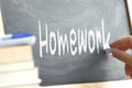 The word Homework hand written on a blackboard. Royalty Free Stock Photo