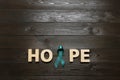 Word Hope made of letters and teal awareness ribbon on wooden background, top view. Symbol of social and medical Royalty Free Stock Photo