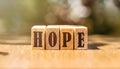 Word HOPE written on blocks of wood on wooden table Royalty Free Stock Photo
