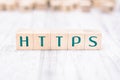 The Word HTTPS Formed By Wooden Blocks On A White Table