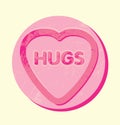 The word hugs in a giant heart shaped sweet or cookie