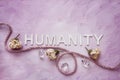 The word, HUMANITY, spelled in capital letters with dried flowers Royalty Free Stock Photo