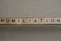 word humiliation made of wooden square letters