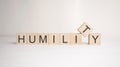 The word humility is written on wooden cubes on a light background. Business concept Royalty Free Stock Photo