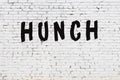 Word hunch painted on white brick wall Royalty Free Stock Photo