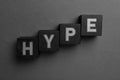 Word Hype of black cubes with letters on grey background, top view Royalty Free Stock Photo