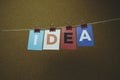 The word IDEA written on colorful note papers on board background. Idea concept Royalty Free Stock Photo