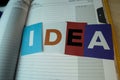 The word IDEA written on colorful note papers on board background. Idea concept Royalty Free Stock Photo