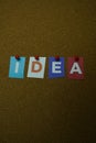 The word IDEA written on colorful note papers on board background. Idea concept