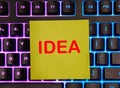 word idea written on yellow paper. The paper is on the keyboard. creative idea Royalty Free Stock Photo