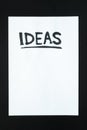 Word `ideas` handwritten on empty paper sheet. Royalty Free Stock Photo