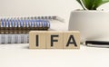the word IFA is written on a wooden cubes structure