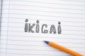 The word Ikigai on notebook sheet and pen