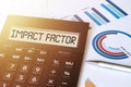 Word impact factor on calculator. Business and finance concept Royalty Free Stock Photo