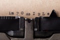Word IMPOSSIBLE with the text IM deleted and then everything is possible written the old typewriter on white page Royalty Free Stock Photo