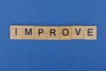 Word improve from brown wooden letters