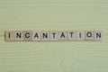 the word incantation of gray small wooden letters