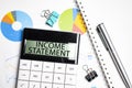 Word INCOME statement on the calculator. Business and tax concept .Calculator, currency, book, tax form, and pen on wooden table. Royalty Free Stock Photo