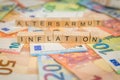 The word inflation - and old age poverty - in German for old age poverty - in the background on banknotes Euro notes written with Royalty Free Stock Photo