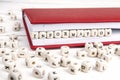 Word Information written in wooden blocks in red notebook on white wooden table.