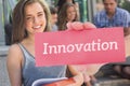 Innovation against pretty student smiling at camera outside Royalty Free Stock Photo