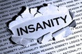 The word insanity in the middle of a sheet of paper is released from meaning