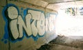 The word `intent` in graffiti on the concrete walls of a highway underpass