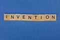 Word invention made of brown wooden letters Royalty Free Stock Photo