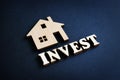 Word Invest and model of home. Real Estate Investment concept