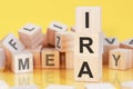 word IRA from wooden blocks with letters, concept