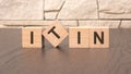 word ITIN block wood on wooden table background