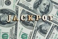 The word Jackpot on the 100 us dollar bills background. Macro view 100 dollar banknotes. Casino or Lotto Cash American Money