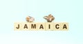 Word Jamaica with wooden cubes and seashells on turquoise