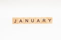 Word JANUARY made of wooden blocks on white background. Concept month of year