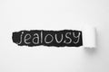 Word JEALOUSY under ripped paper as background